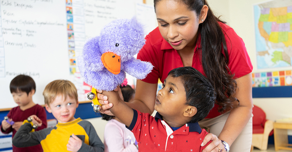 teacher helping student with puppet